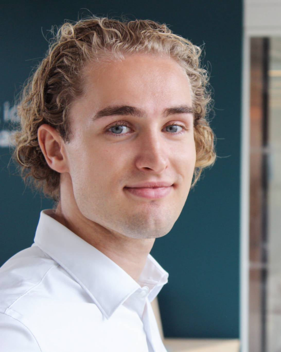 Portrait of founder Birk Clemens Riis wearing a white shirt, representing the personal commitment behind Nordisk Family