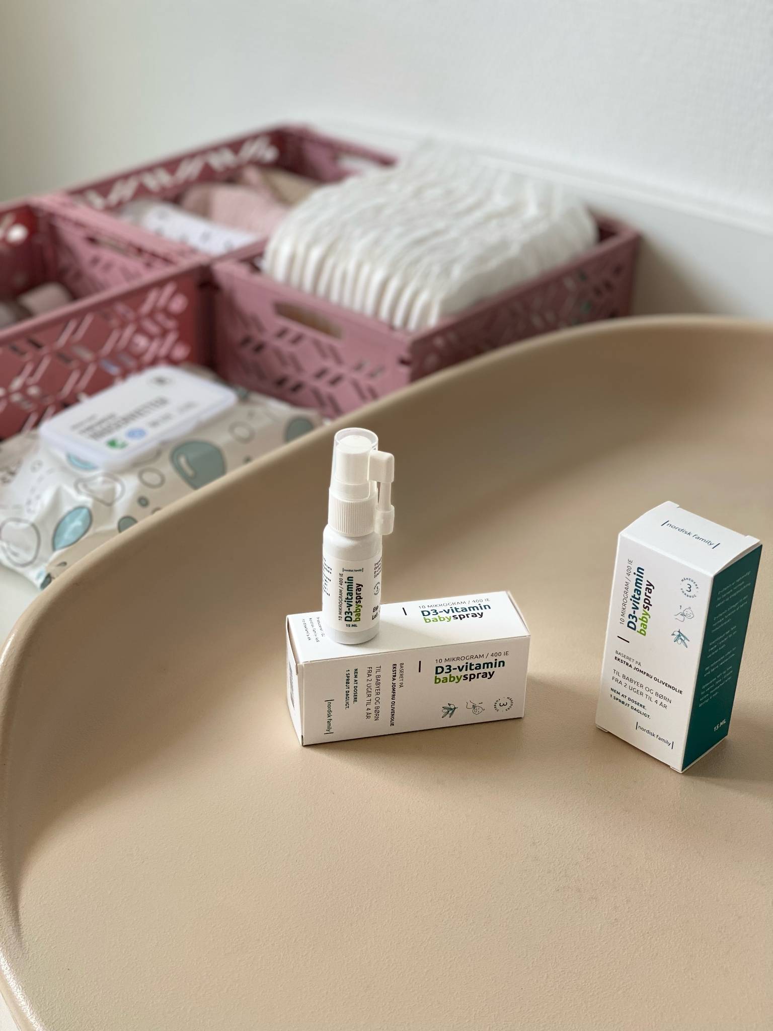 Nordisk Family Vitamin D3 spray standing on changing table among daily baby care essentials